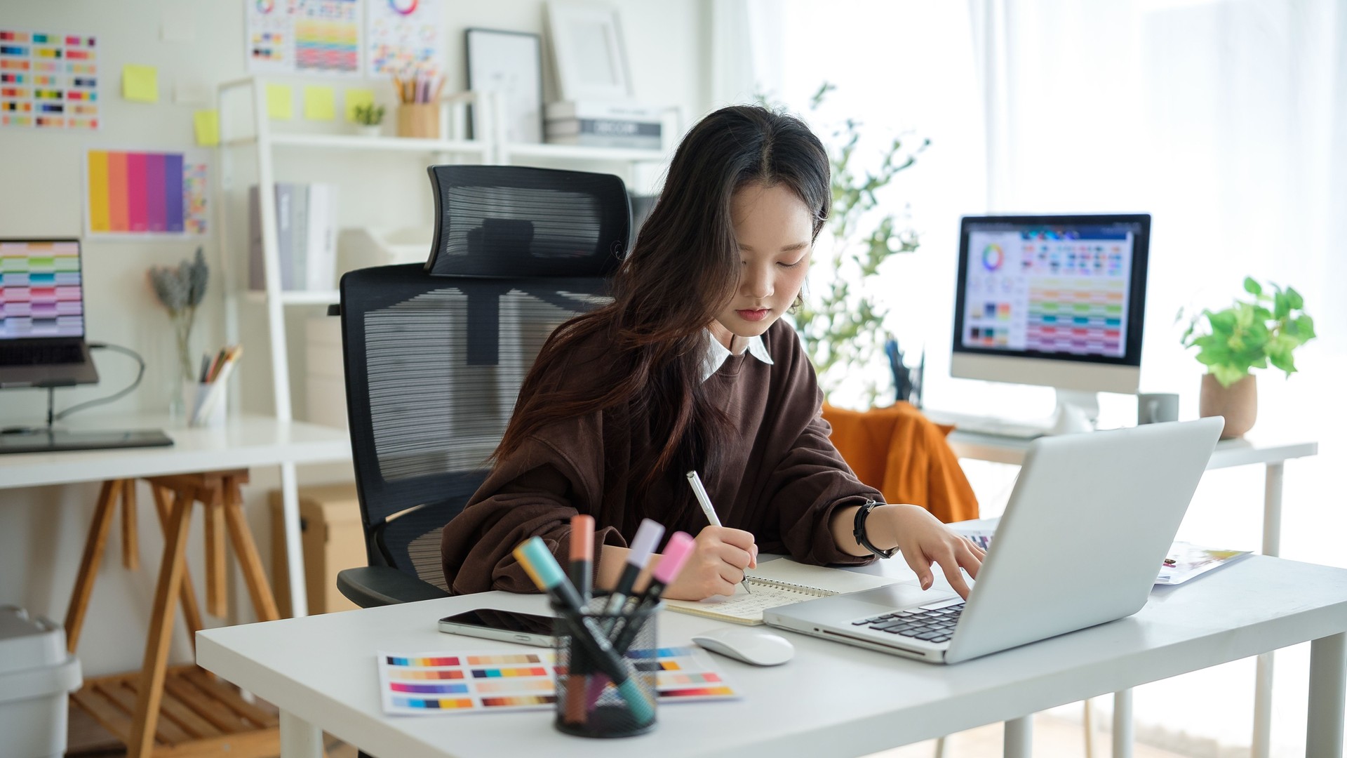 Young graphic designer focused on project in creative studio.